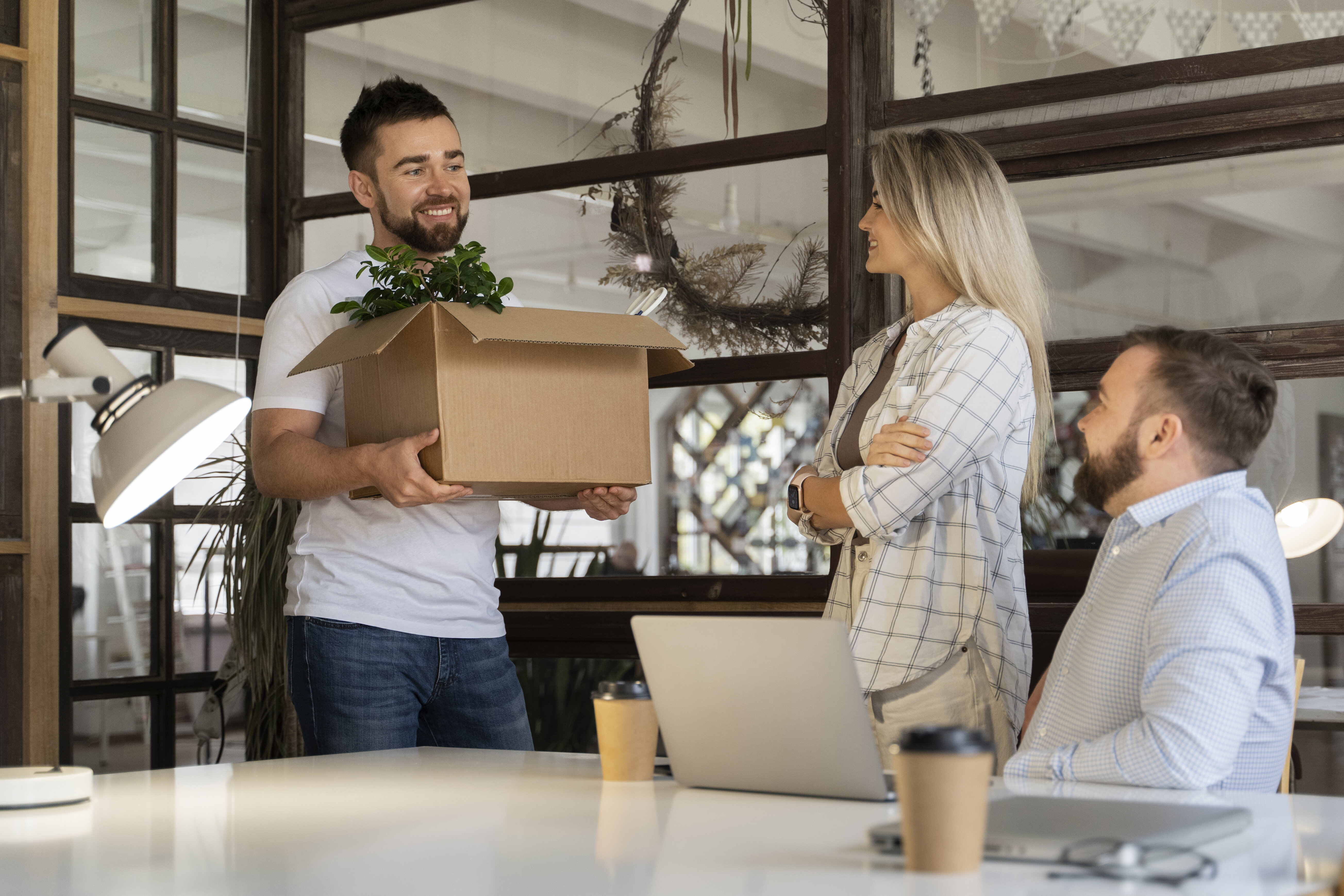  Happy employees communicating with each other in an open office