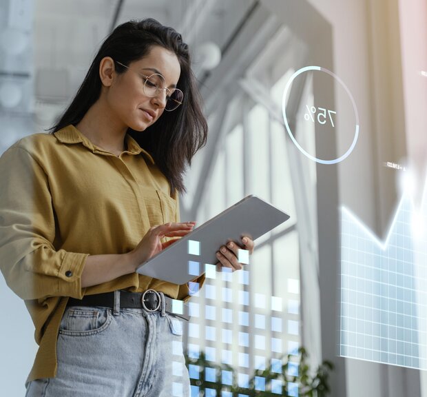 Woman using a tablet displaying a chart that visualizes data