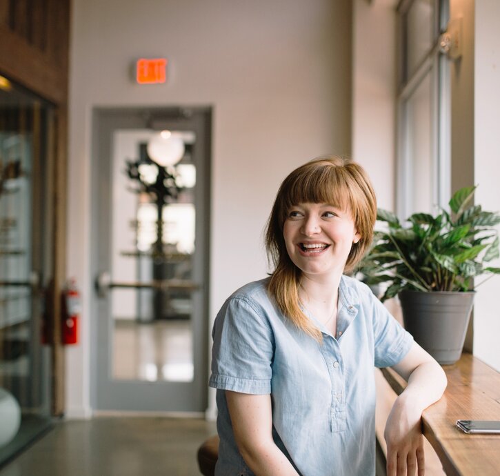 A happy employee is sitting at the desk