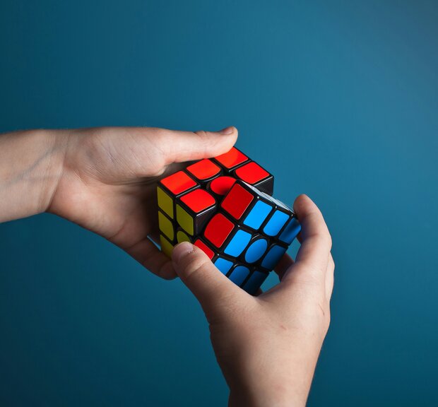 A man stacks a Rubik's Cube